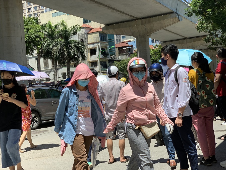 A group of people walking on a sidewalkDescription automatically generated with low confidence